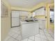 Bright kitchen featuring white cabinetry and an island with cooktop, offering ample counter space at 503 Clubside Cir # 47, Venice, FL 34293