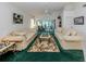 Spacious living room with large couches and lush green carpet at 503 Clubside Cir # 47, Venice, FL 34293