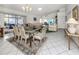 Open-concept space featuring a dining area and living room with tile flooring and plenty of natural light at 503 Clubside Cir # 47, Venice, FL 34293