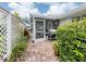 Outdoor patio with a brick floor, grill, and surrounding landscaping and a covered, screened in area at 503 Clubside Cir # 47, Venice, FL 34293