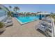 Resort-style pool featuring comfortable lounge chairs and umbrellas for residents' relaxation and enjoyment at 503 Clubside Cir # 47, Venice, FL 34293