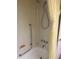 Bright bathroom featuring a shower with a grab bar and white bathtub with yellow and white striped curtain at 508 Vasto Dr, Venice, FL 34285