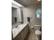 Bathroom with single sink vanity and a window with decoratively patterned curtains at 508 Vasto Dr, Venice, FL 34285