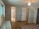 View of the bedroom leading to a bathroom and closet space with wood paneling at 508 Vasto Dr, Venice, FL 34285