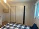 Bedroom closet features a wood-look laminate closet door and laminate flooring at 508 Vasto Dr, Venice, FL 34285