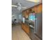 Kitchen with stainless steel appliances and wooden cabinets with dark countertops at 508 Vasto Dr, Venice, FL 34285