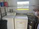 Functional laundry room with washer, dryer, water heater, and natural light at 508 Vasto Dr, Venice, FL 34285