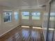 The sunroom is surrounded by bright, natural light and laminate flooring at 508 Vasto Dr, Venice, FL 34285