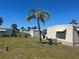 Exterior view of well-manicured lawns with palm trees throughout a quiet community at 508 Vasto Dr, Venice, FL 34285