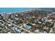 An aerial view of a neighborhood near a beach with various rooftops, trees, and the ocean in the background at 509 Alhambra Rd, Venice, FL 34285