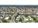 Wide aerial shot showcasing a community with canal access, roads, and lush greenery at 51 Oakwood N Dr # 51, Englewood, FL 34223