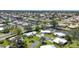Residential aerial showcasing homes with lush landscaping and waterfront access via canals at 51 Oakwood N Dr # 51, Englewood, FL 34223