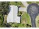 Aerial view highlighting the roof, driveway, and surrounding greenery of a well-maintained home at 51 Oakwood N Dr # 51, Englewood, FL 34223