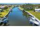 Aerial view of the canal showcasing boat docks and waterfront properties along the waterway at 51 Oakwood N Dr # 51, Englewood, FL 34223