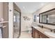 Modern bathroom featuring dual sinks, a spacious shower, and neutral tones at 51 Oakwood N Dr # 51, Englewood, FL 34223