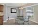 Cozy dining area featuring a glass-top table and decorative lighting at 51 Oakwood N Dr # 51, Englewood, FL 34223