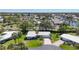 Charming single-story home featuring a well-manicured lawn, mature trees, and a circular driveway at 51 Oakwood N Dr # 51, Englewood, FL 34223