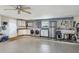 Spacious garage featuring epoxy flooring, laundry area, utility sink, and stainless steel refrigerator at 51 Oakwood N Dr # 51, Englewood, FL 34223