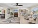 Inviting living room featuring a ceiling fan, modern furnishings, and large windows at 51 Oakwood N Dr # 51, Englewood, FL 34223