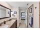 Bathroom featuring double sinks and an open doorway to the main bedroom at 51 Oakwood N Dr # 51, Englewood, FL 34223