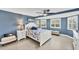 Comfortable bedroom with bright natural light and coastal-inspired decor and ceiling fan at 51 Oakwood N Dr # 51, Englewood, FL 34223