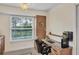 Office space with a built-in desk, storage cabinets, and a view of the greenery outside at 51 Oakwood N Dr # 51, Englewood, FL 34223