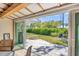 Covered patio with paver flooring, privacy landscaping, and sliding glass door access at 51 Oakwood N Dr # 51, Englewood, FL 34223