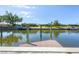 Scenic waterfront view featuring a private dock, lush greenery, and beautiful blue waters at 51 Oakwood N Dr # 51, Englewood, FL 34223