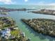 Stunning aerial view of the coastal waterway showcasing neighborhood with waterfront homes, docks, and boats at 524 Lyons Bay Rd, Nokomis, FL 34275