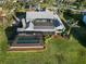 Aerial shot showcases the property's layout, pool, and screened lanai, set amidst a beautifully manicured lawn at 524 Lyons Bay Rd, Nokomis, FL 34275