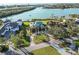 Aerial view of the waterfront property showcasing its lush landscaping, circular driveway, and water access at 524 Lyons Bay Rd, Nokomis, FL 34275