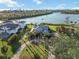 Aerial view of the waterfront property with lush landscaping, circular driveway, and stunning water views at 524 Lyons Bay Rd, Nokomis, FL 34275