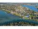 Stunning aerial view of waterfront homes along a scenic Florida bay, with lush greenery and sparkling waters at 524 Lyons Bay Rd, Nokomis, FL 34275