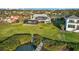 Expansive backyard featuring a screened pool, lush lawn, private dock, and serene waterfront views at 524 Lyons Bay Rd, Nokomis, FL 34275