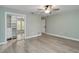 Open bedroom with light wood floors, large closet with mirrored doors and a ceiling fan at 524 Lyons Bay Rd, Nokomis, FL 34275