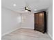 Bright bedroom featuring wood floors, ceiling fan, plantation shutters, and a dark wood armoire at 524 Lyons Bay Rd, Nokomis, FL 34275