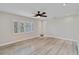 Light-filled bedroom with neutral walls, plantation shutters, and sleek, light-colored flooring at 524 Lyons Bay Rd, Nokomis, FL 34275