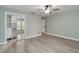 Spacious bedroom with wood floors, a fan and light fixture, and a mirrored closet at 524 Lyons Bay Rd, Nokomis, FL 34275