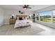 Beautiful bedroom with a woven headboard, stylish decor, and a large window overlooking a green landscape at 524 Lyons Bay Rd, Nokomis, FL 34275