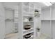 Bright, organized walk-in closet featuring built-in shelving and ample storage space for clothes and accessories at 524 Lyons Bay Rd, Nokomis, FL 34275