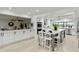 Modern kitchen featuring white cabinets, a large island, and stainless steel appliances at 524 Lyons Bay Rd, Nokomis, FL 34275