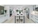 Spacious white kitchen with a large center island, stainless steel appliances, and plenty of cabinet space at 524 Lyons Bay Rd, Nokomis, FL 34275