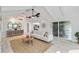 Open concept living room with vaulted ceilings, modern decor, and access to the outdoor patio at 524 Lyons Bay Rd, Nokomis, FL 34275