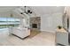 Bright living room with vaulted ceilings, stone fireplace, and a view of the pool and waterway at 524 Lyons Bay Rd, Nokomis, FL 34275