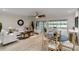 Comfortable living room with stylish furniture, fan, and views of the outdoor scenery at 524 Lyons Bay Rd, Nokomis, FL 34275