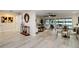 Open-concept living area with wood-look floors, fan, and sliding glass doors to the outdoor area at 524 Lyons Bay Rd, Nokomis, FL 34275