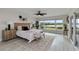 Serene main bedroom features water views, neutral decor, and a comfortable seating area at 524 Lyons Bay Rd, Nokomis, FL 34275