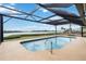 Screened-in pool with a stunning waterfront view, perfect for enjoying a refreshing swim while admiring the scenery at 524 Lyons Bay Rd, Nokomis, FL 34275