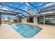 Sparkling pool with screen enclosure, seamlessly connected to the home's interior through sliding glass doors at 524 Lyons Bay Rd, Nokomis, FL 34275