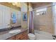 Bathroom featuring granite countertops, a shower-tub combination, and natural light at 5550 Rock Dove Dr, Sarasota, FL 34241